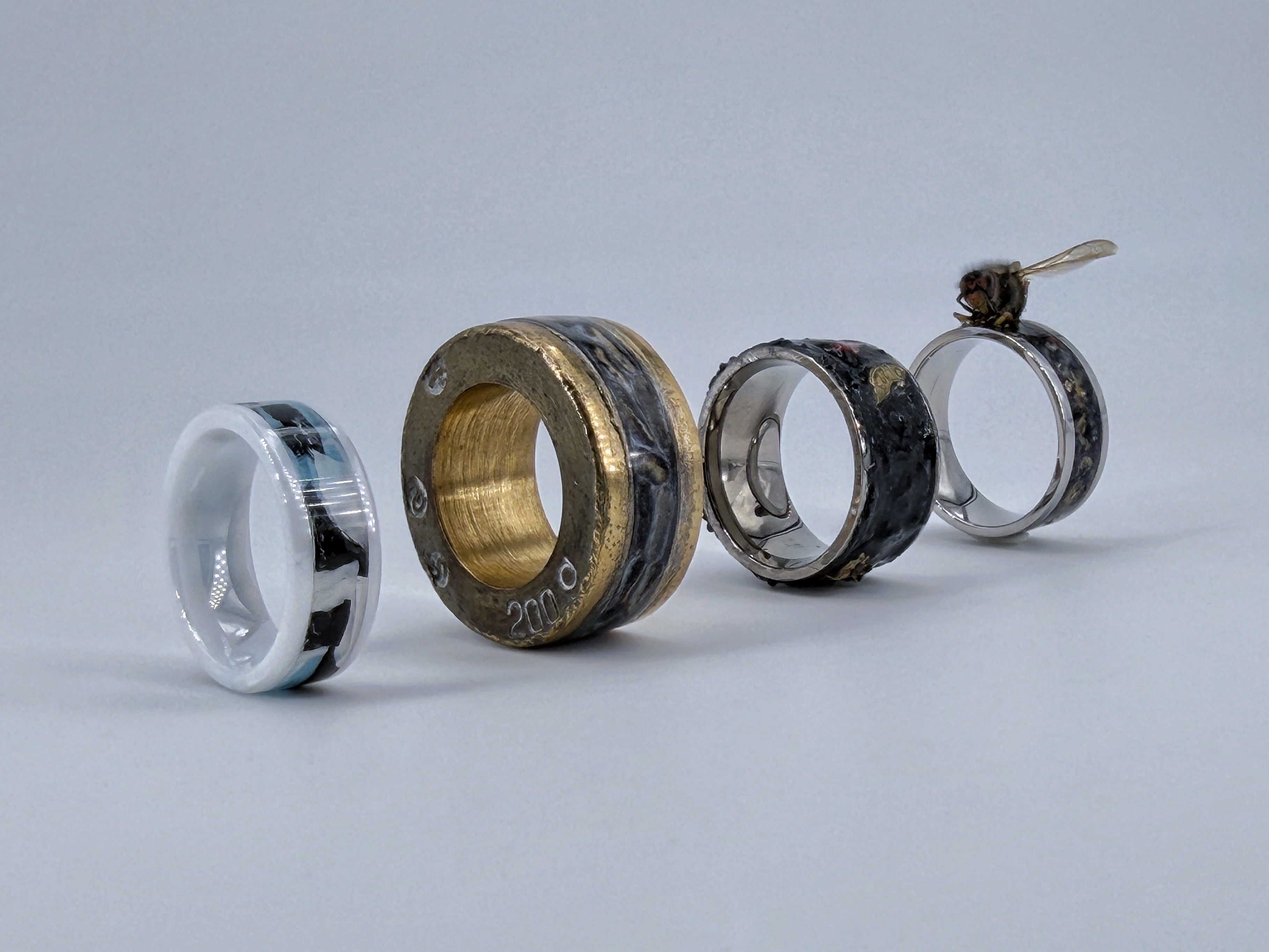 Four handcrafted contemporary ring sculptures representing the Four Horsemen: Hunger, Illness, War and Death, displayed side by side on a neutral background.